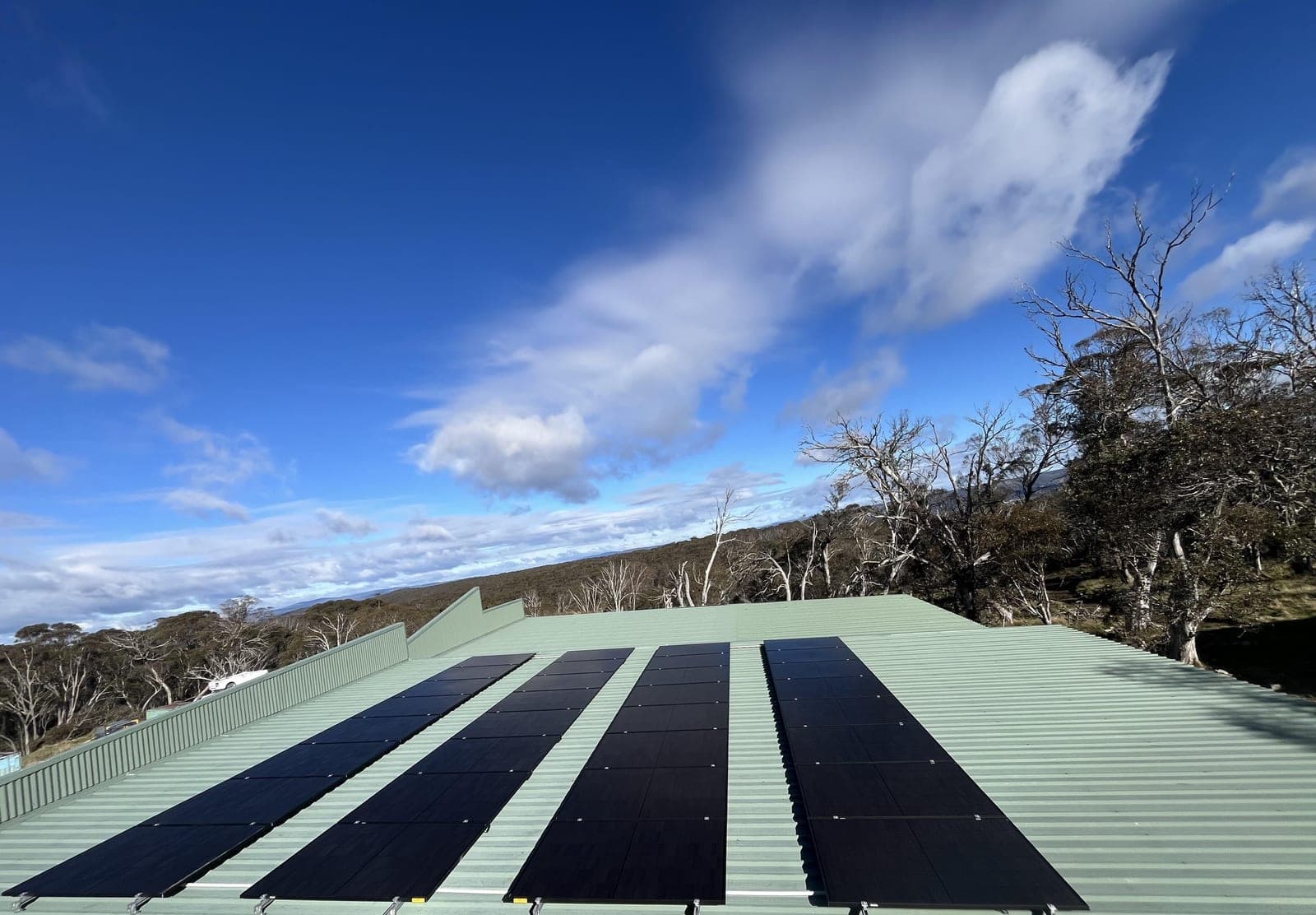 Solar panels installed on a rooftop under a blue sky